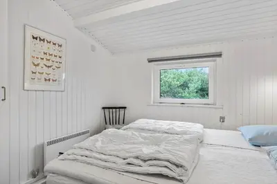 a bed in a white room with a window at 410-Thisted-Julius-Poulsens-Vej-13 in Thisted