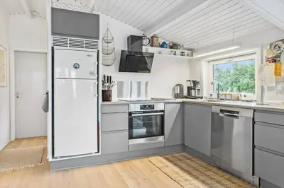 a kitchen with stainless steel appliances and a white refrigerator at 410-Thisted-Julius-Poulsens-Vej-13 in Thisted
