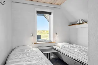 a bedroom with two beds and a window at 394-Vestervig-Magevej-43 in Vestervig