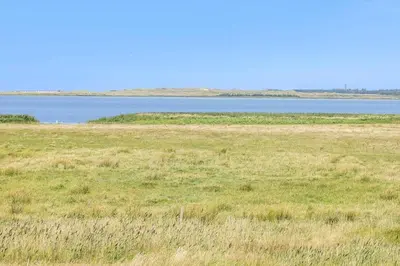 a field of grass with a large body of water at 394-Vestervig-Magevej-43 in Vestervig