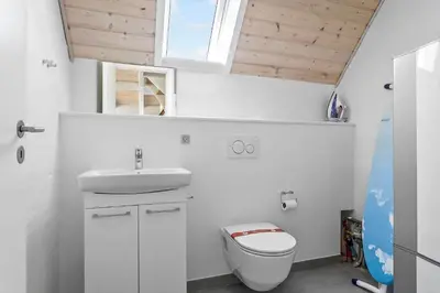 a bathroom with a toilet and a sink and a window at 394-Vestervig-Magevej-43 in Vestervig