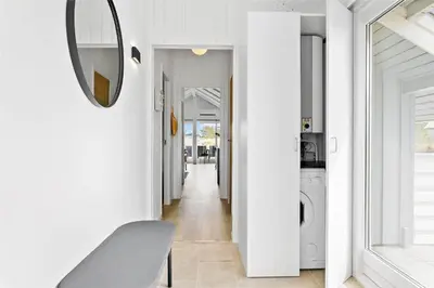 a hallway with white walls and a mirror on a wall at 620-Thisted-Pighvarvej-20 in Thisted