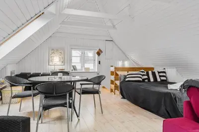 a room with a bed and a table and chairs at 893-Thisted-Vesterhavsgade-148 in Thisted