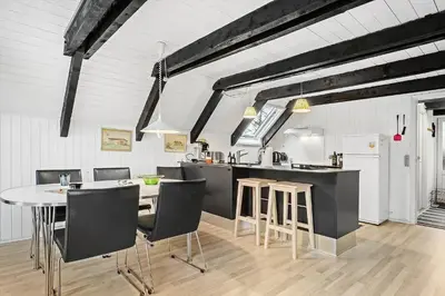 a kitchen and dining room with a table and chairs at 621-Thisted-Molgaardsvej-21 in Thisted
