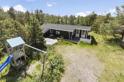 a small house with a slide and a playground at 711-Thisted-Blamunkevej-24 in Thisted