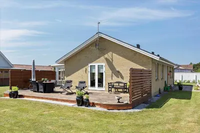 a small house with a deck and a picnic table at 110-Vestervig-Svanholmvej-10 in Vestervig