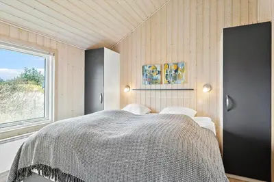 a bedroom with a large bed and a window at 362-Thisted-Ostersvej-1 in Thisted