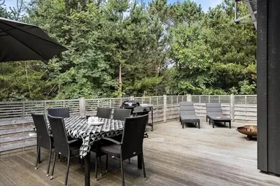 a patio with a table and chairs and an umbrella at 466-Thisted-Muslingevej-6 in Thisted