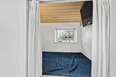 a room with a blue bed and a window at 433-Thisted-Tunvej-20 in Thisted