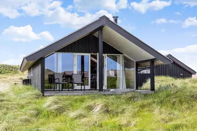 a house on top of a hill with glass at 915-Thisted-P-Bolesens-Vej-11 in Torsted