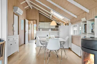 a kitchen with a table and chairs in a room at 915-Thisted-P-Bolesens-Vej-11 in Torsted