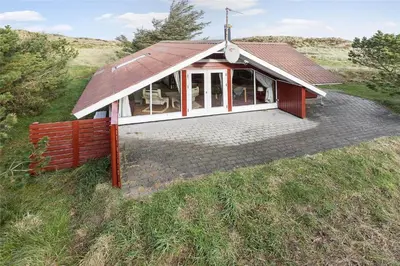 a small house with a roof on a field at 340-Thisted-Delfinvej-25 in Thisted