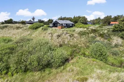 a house sitting on top of a grassy hill at 643-Thisted-Bredkaervej-69-A in Thisted