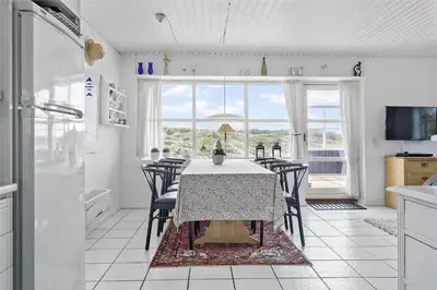 a dining room with a table and chairs in a kitchen at 643-Thisted-Bredkaervej-69-A in Thisted