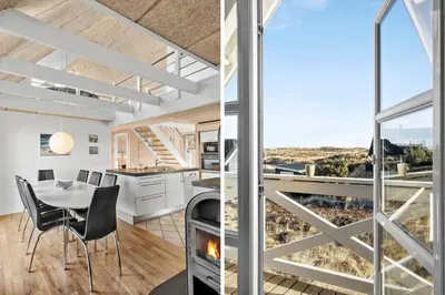 a kitchen and dining room with a fireplace in a house at 718-Thisted-Orredvej-36 in Thisted