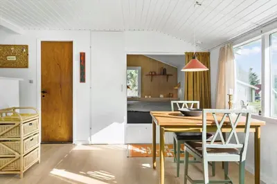 a kitchen and dining room with a table and chairs at 114-Thisted-Tunvej-14 in Thisted