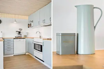 a kitchen with white cabinets and a stainless steel refrigerator at 132-Thisted-Sotungevej-31 in Thisted