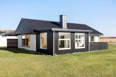 a black and white house with a grass yard at 132-Thisted-Sotungevej-31 in Thisted