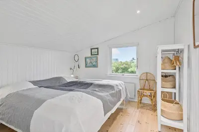 a white bedroom with a bed and a chair at 635-Thisted-Store-Knuds-Vej-6 in Thisted