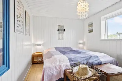 a bedroom with a bed and a table and a chandelier at 635-Thisted-Store-Knuds-Vej-6 in Thisted
