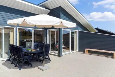 a table with an umbrella on a patio at 524-Thisted-Flyndervej-4 in Thisted