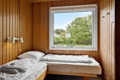 two beds in a room with a window at 140-Vestervig-Bekkasinvej-14 in Vestervig