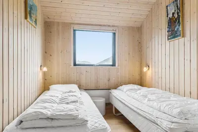 two beds in a room with a window at 939-Thisted-Niels-Vognmands-Vej-3 in Torsted