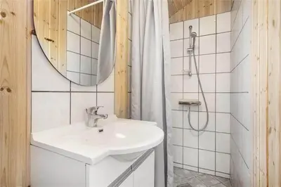 a white bathroom with a sink and a shower at 939-Thisted-Niels-Vognmands-Vej-3 in Torsted