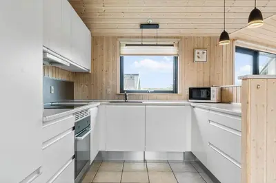 a kitchen with white cabinets and a window at 939-Thisted-Niels-Vognmands-Vej-3 in Torsted