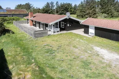 a house with a porch and a picnic table on a yard at 318-Thisted-Nordsovej-204-A in Thisted