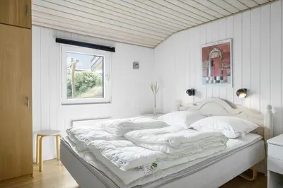 a white bed in a white room with a window at 305-Thisted-Fiskervej-35 in Thisted