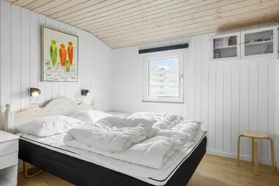 a bedroom with a bed with white sheets and a window at 305-Thisted-Fiskervej-35 in Thisted