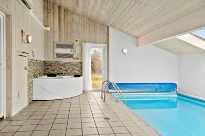 a bathroom with a swimming pool and a tub at 970-Thisted-Klitstien-47 in Torsted
