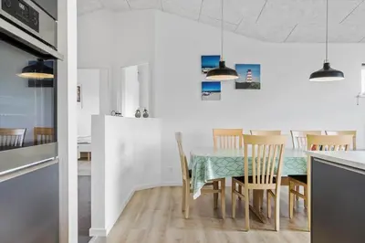 a kitchen and dining room with a table and chairs at 105-Thisted-Gronkaervej-19-B in Thisted