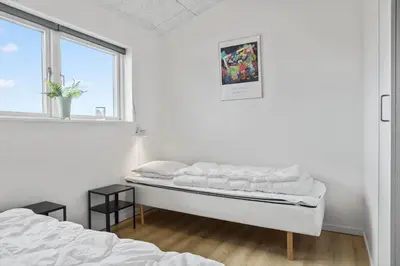 a white room with a bed and a window at 105-Thisted-Gronkaervej-19-B in Thisted