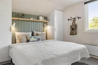 a bedroom with a white bed and a window at 962-Thisted-Bavnbak-27 in Torsted
