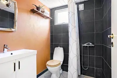 a bathroom with a toilet and a shower at 962-Thisted-Bavnbak-27 in Torsted