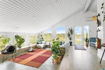 a living room with potted plants and a couch at 962-Thisted-Bavnbak-27 in Torsted