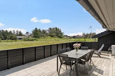 a wooden deck with a table and chairs on it at 786-Thisted-Flyndervej-6 in Thisted