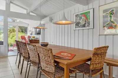 a dining room with a wooden table and chairs at 1003-Thisted-Ajs-Molls-Vej-2 in Torsted