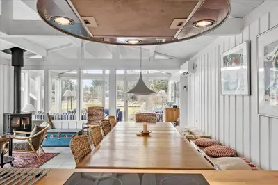 a dining room with a large wooden table and chairs at 1003-Thisted-Ajs-Molls-Vej-2 in Torsted