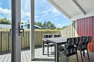 a patio with a table and chairs on a deck at 715-Thisted-Tunvej-22 in Thisted