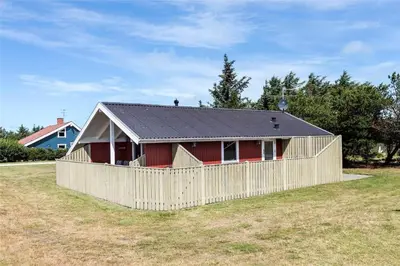 a red house with a fence in a field at 715-Thisted-Tunvej-22 in Thisted