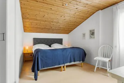 a bedroom with a bed with a wooden ceiling at 837-Thisted-Flyndervej-17 in Thisted
