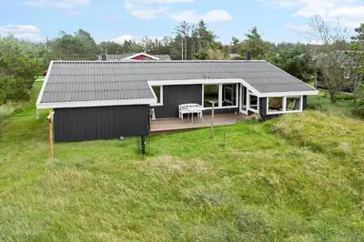 a small house on a hill with a yard at 837-Thisted-Flyndervej-17 in Thisted