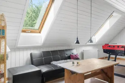 a living room with a couch and a table and a piano at 100-Thisted-Kapelvej-1 in Thisted