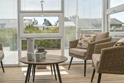 a living room with chairs and a table and a window at 514-Thisted-Fiskervej-53 in Thisted