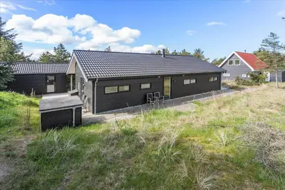 a black house on the side of a hill at 171-Thisted-Molgaardsvej-71 in Thisted