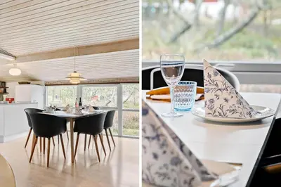 a kitchen and dining room with a table with a glass of wine at 746-Thisted-Blamunkevej-36 in Thisted