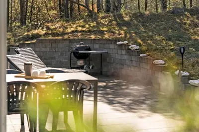 a patio with a table and chairs and a grill at 746-Thisted-Blamunkevej-36 in Thisted